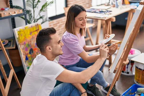 stock image Man and woman artists couple smiling confident drawing at art studio