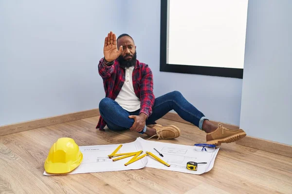 African American Man Sitting Floor New Home Looking Blueprints Doing — Stock Photo, Image