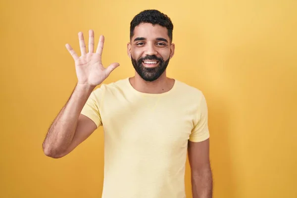 Hispanic Man Beard Standing Yellow Background Showing Pointing Fingers Number — 스톡 사진