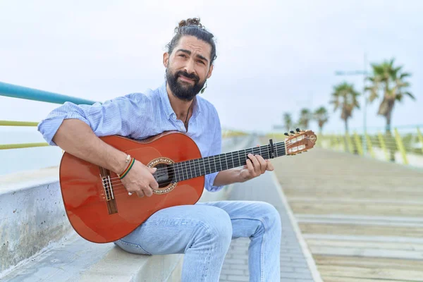 Young Hispanic Man Musician Playing Classical Guitar Sitting Bench Seaside — Stok fotoğraf