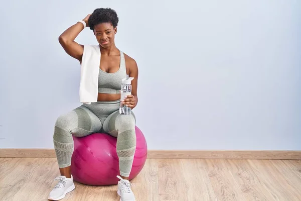 Mujer Afroamericana Usando Ropa Deportiva Sentada Pelota Pilates Confundir Preguntarse —  Fotos de Stock