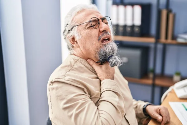 stock image Middle age grey-haired man business worker suffering for throat pain working at office