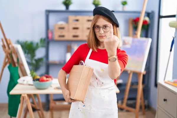 Young Redhead Woman Art Studio Holding Art Case Showing Middle —  Fotos de Stock