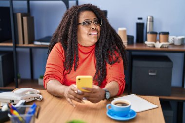African american woman business worker using smartphone drinking coffee at office