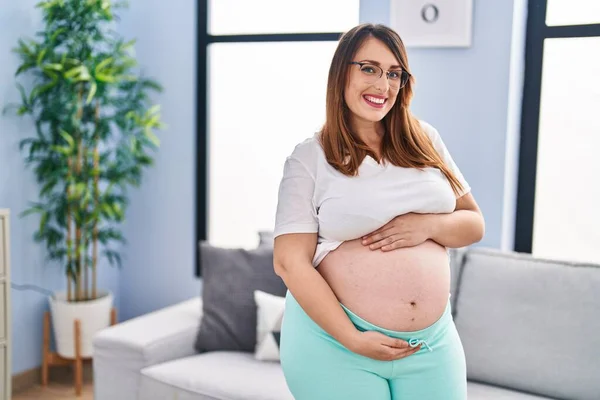 Young Pregnant Woman Smiling Confident Touching Belly Home — Stockfoto