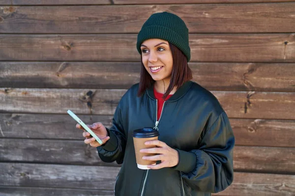 Young Beautiful Hispanic Woman Using Smartphone Drinking Coffee Isolated Wooden — Stock Photo, Image
