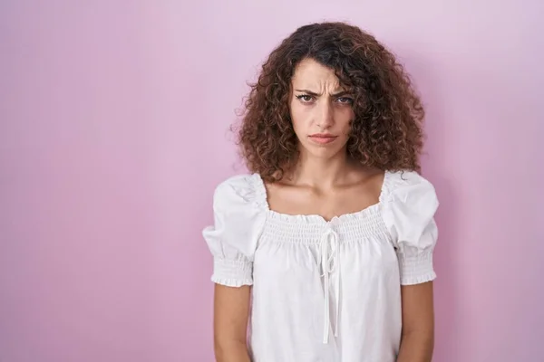 Hispanic Woman Curly Hair Standing Pink Background Skeptic Nervous Frowning — Zdjęcie stockowe