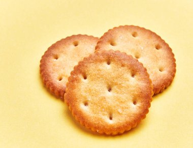  Delicious group of salty biscuits over isolated yellow background