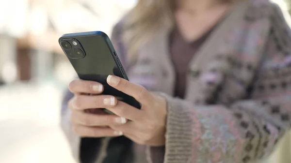 stock image Young blonde woman using smartphone at street