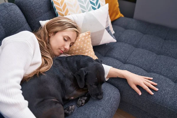 Young Blonde Woman Lying Sofa Sleeping Dog Home — Stockfoto