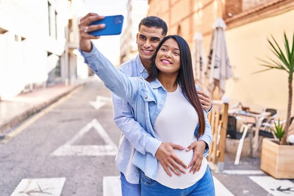 Young Latin Couple Expecting Baby Making Selfie Smartphone Street — Stockfoto