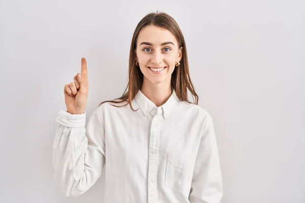 Young Caucasian Woman Standing Isolated Background Showing Pointing Finger Number — Photo