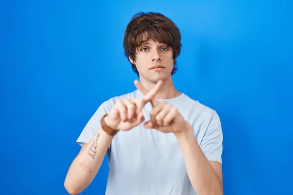 Hispanic Young Man Standing Blue Background Rejection Expression Crossing Fingers — Fotografia de Stock