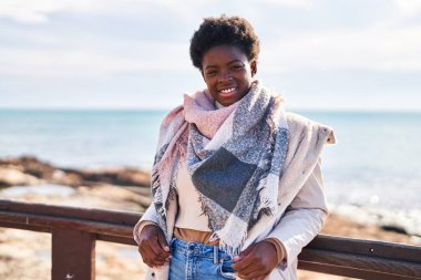 African american woman smiling confident standing at seaside