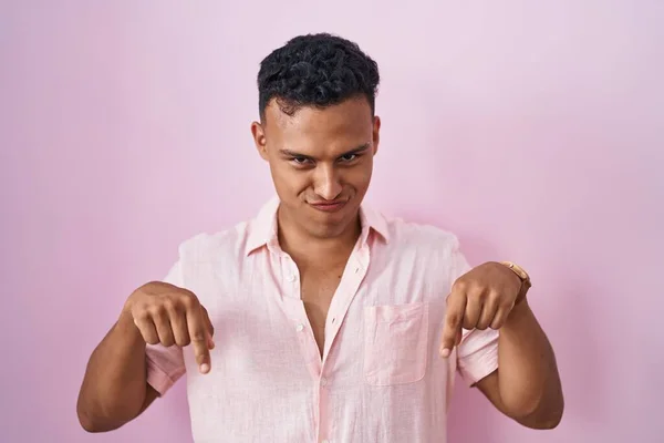 Young Hispanic Man Standing Pink Background Pointing Looking Sad Upset — Stock Photo, Image