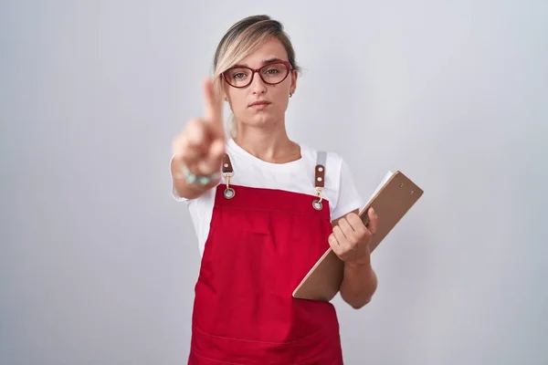 Young Blonde Woman Wearing Waiter Uniform Holding Clipboard Pointing Finger — Stock Photo, Image