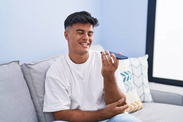 Young Hispanic Man Talking Smartphone Sitting Sofa Home — Foto de Stock