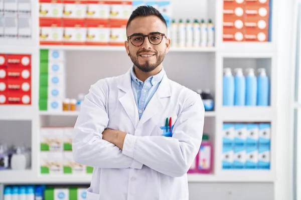 Young Hispanic Man Pharmacist Smiling Confident Standing Arms Crossed Gesture — Zdjęcie stockowe
