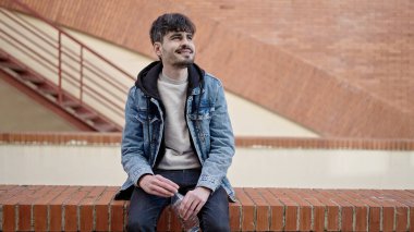 Young hispanic man smiling confident at street
