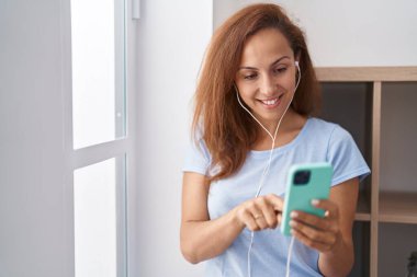 Young woman smiling confident listening to music at home