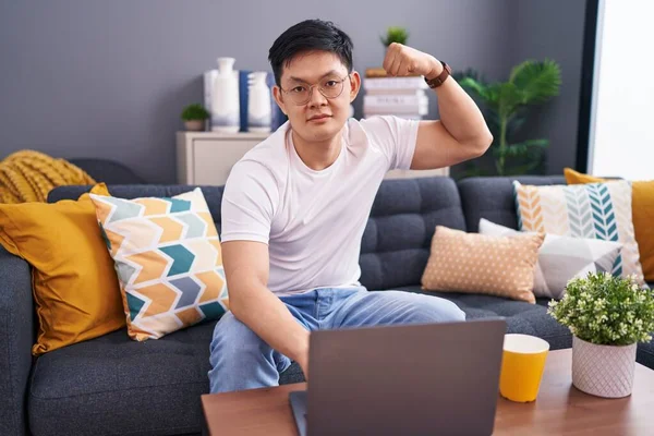 Young Asian Man Using Laptop Home Sitting Sofa Strong Person — Stock Photo, Image