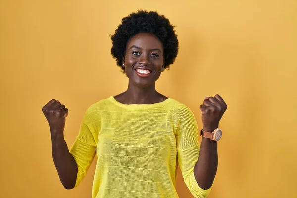 African Young Woman Standing Yellow Studio Celebrating Surprised Amazed Success — Stock Photo, Image