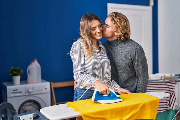 男と女カップルアイロン服接吻でランドリールーム — ストック写真