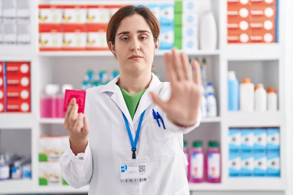 Brunette Woman Working Pharmacy Drugstore Holding Condom Open Hand Doing — Stock Photo, Image