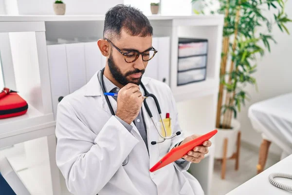 Young Hispanic Man Doctor Using Touchpad Working Clinic — Fotografia de Stock