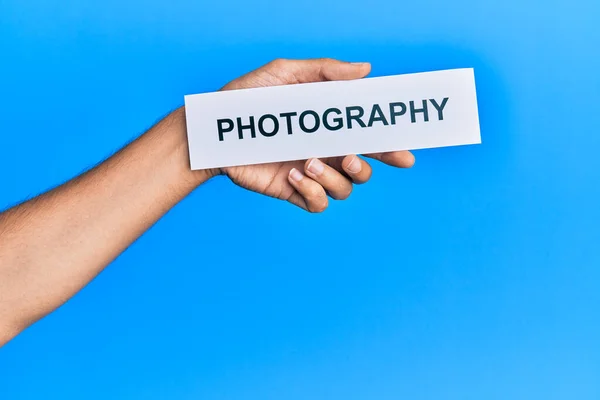 Hand Caucasian Man Holding Paper Photography Word Isolated Blue Background — Stock fotografie