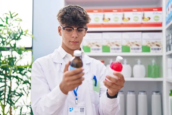 Young Hispanic Teenager Pharmacist Holding Medication Bottles Pharmacy — Zdjęcie stockowe