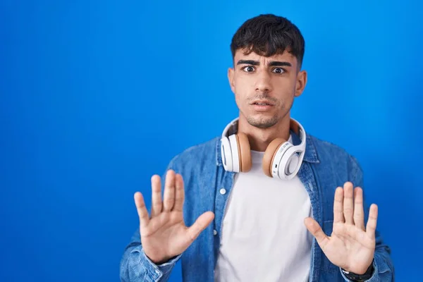 Young Hispanic Man Standing Blue Background Moving Away Hands Palms — Stok fotoğraf