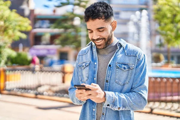 Jonge Spaanse Man Glimlacht Vol Vertrouwen Met Smartphone Het Park — Stockfoto