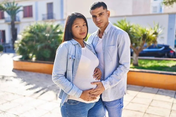 Young Latin Couple Expecting Baby Hugging Each Other Standing Park — Stockfoto