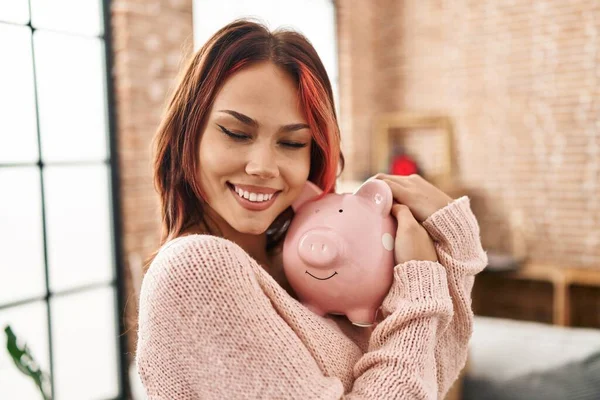 Young Caucasian Woman Smiling Confident Hugging Piggy Bank New Home — Fotografia de Stock