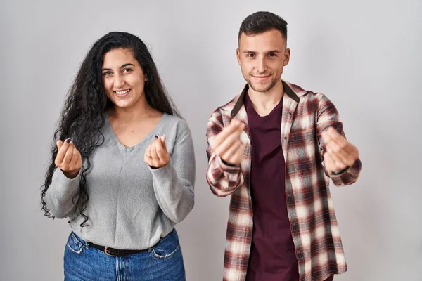 Young Hispanic Couple Standing White Background Doing Money Gesture Hands — Stock Photo, Image