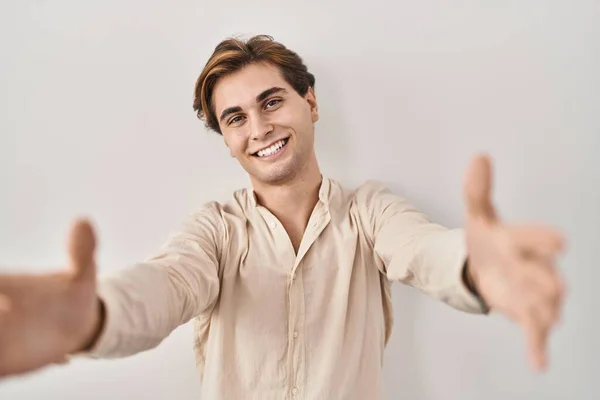 Young Man Standing Isolated Background Looking Camera Smiling Open Arms — Stockfoto