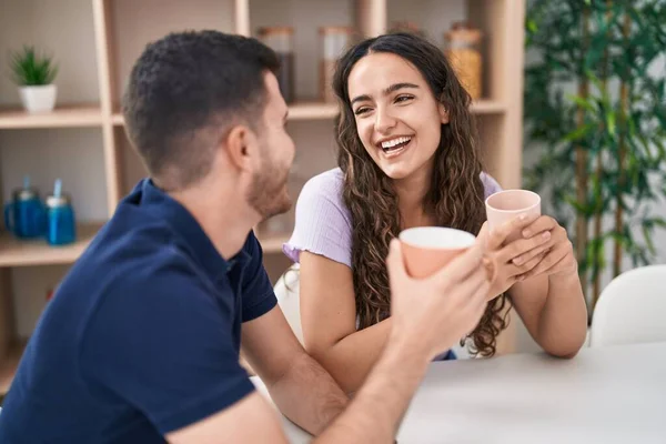 Young Hispanic Couple Drinking Coffee Sitting Table Home — Stockfoto