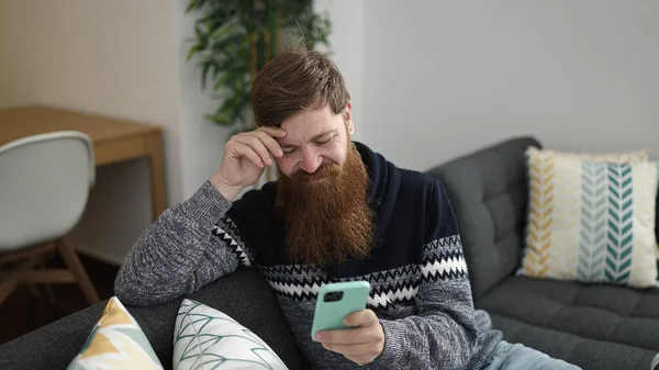 Young Redhead Man Using Smartphone Sitting Sofa Home — 图库照片