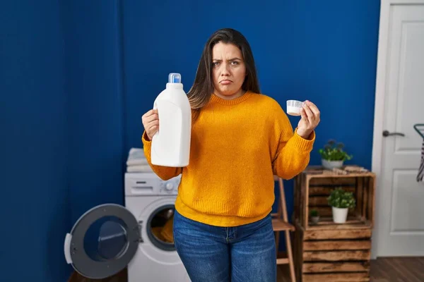 Young Hispanic Woman Holding Detergent Bottle Depressed Worry Distress Crying — Stock Photo, Image