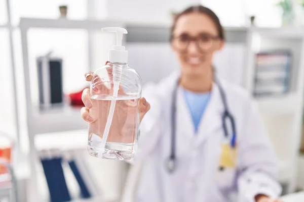 Young Beautiful Hispanic Woman Doctor Holding Sanitizer Gel Hands Bottle — Stockfoto
