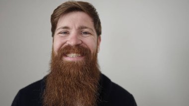 Young redhead man smiling confident standing over isolated white background