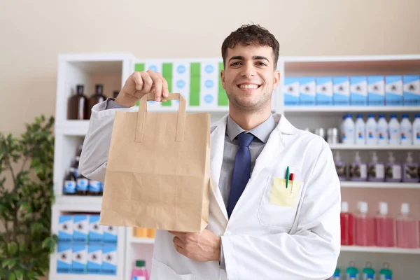Молодой Латиноамериканец Фармацевт Улыбается Уверенно Держа Сумку Аптеке — стоковое фото
