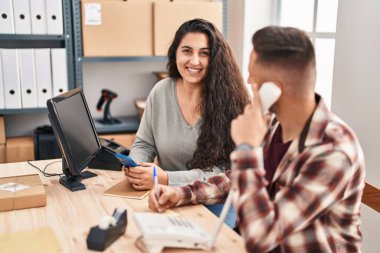 Man and woman ecommerce bussines workers working at office