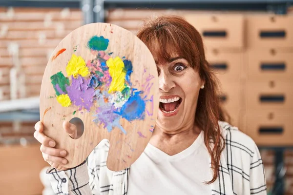 Middle Age Hispanic Woman Holding Palette Covering Face Celebrating Crazy — Stock Photo, Image