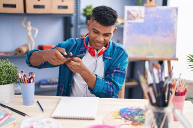 Young latin man artist make photo to draw at art studio