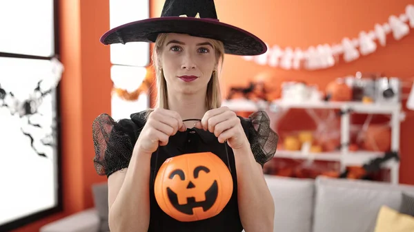 Young Blonde Woman Wearing Witch Costume Holding Pumpkin Basket Home — Fotografia de Stock