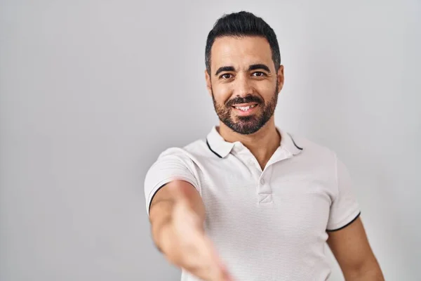 Mladý Hispánec Plnovousem Oblečený Neformálního Oblečení Bílém Pozadí Přátelsky Usmívá — Stock fotografie
