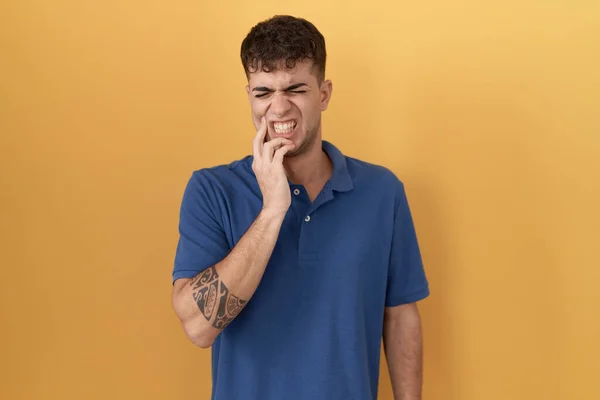 Young Hispanic Man Standing Yellow Background Touching Mouth Hand Painful — Stock Photo, Image