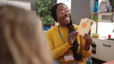 African woman preschool teacher on a vocabulary lesson at kindergarten